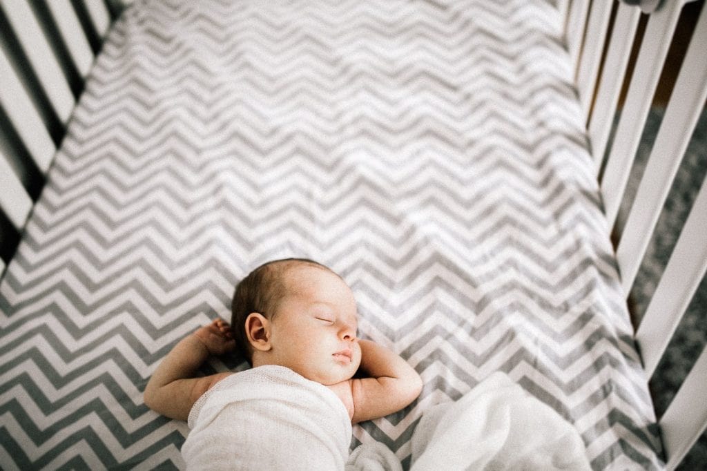 newborn baby in crib
