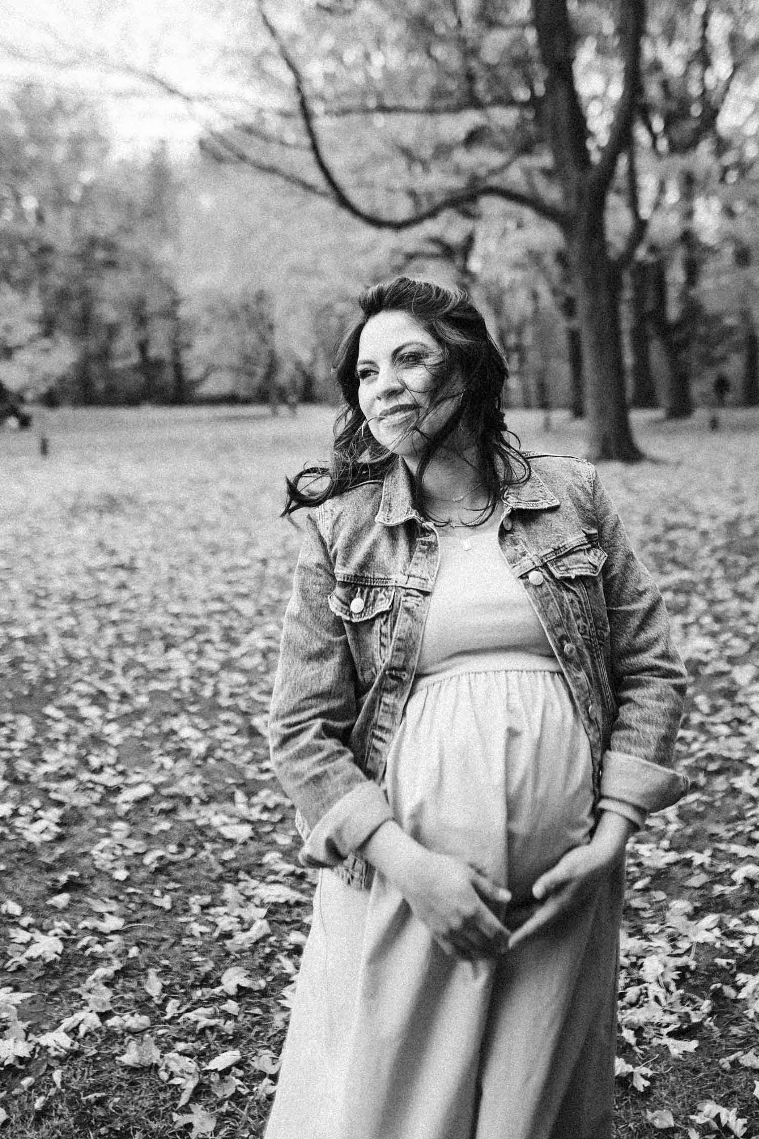 pregnant woman during photoshoot at mount royal park in autumn