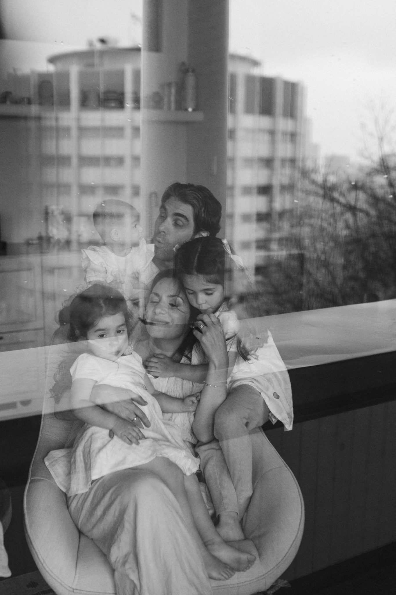 Family huddled together in their home in montreal during their family photo session